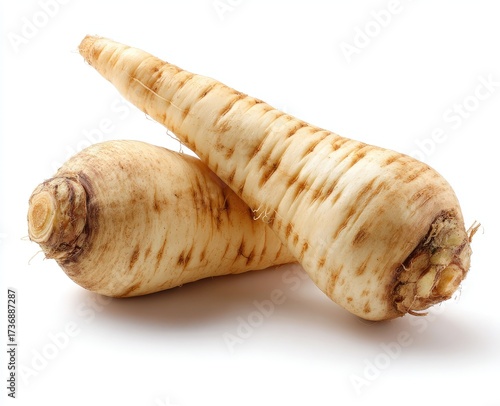 Two elongated, cream-colored root vegetables with brown tips and a few surface blemishes