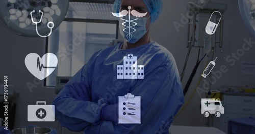 Surgeon donning gloves while preparing surgery with medical icons fading on transparent background