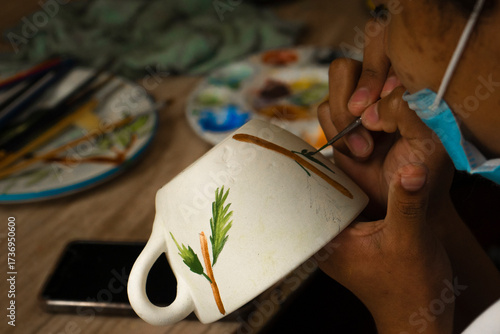 Artisan woman painting ceramics (detail)