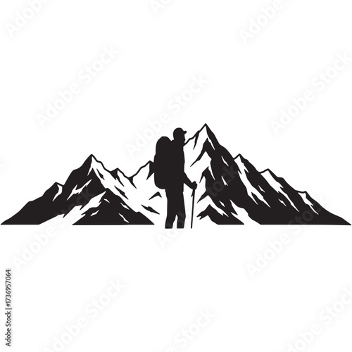 Hiker standing with trekking pole against mountain silhouette