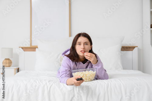 Young woman with remote con...