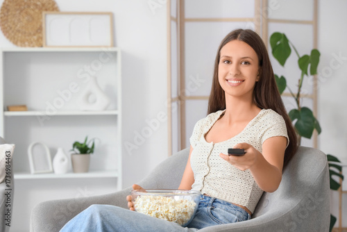 Young woman with remote con...
