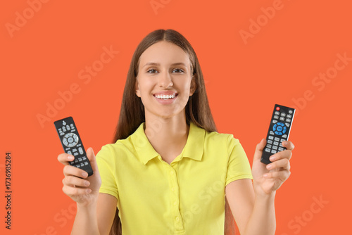Young woman with TV remote ...