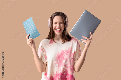Education and student life, happy young woman with headphones holding noteboo...