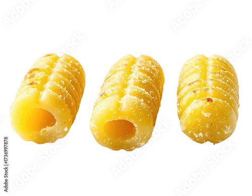 Three pieces of pasta, a light golden color,  with a ridged texture