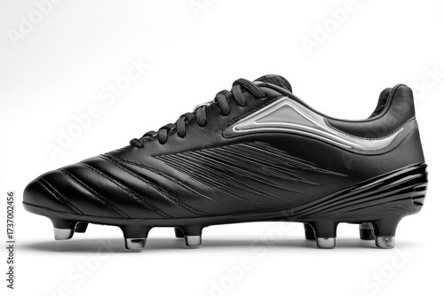 A close-up, side view of a sleek, black soccer cleat with metallic accents and studs