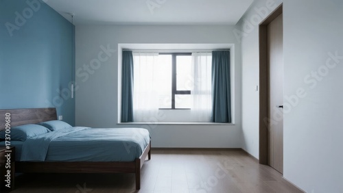 Minimalist bedroom with wooden bed, blue bedding, and large window with curtains