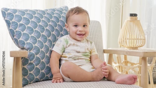 Baby Sitting on Chair in Bright Coastal Home Interior