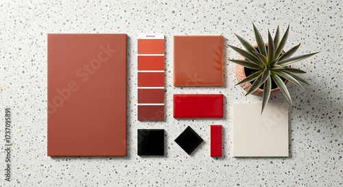 Ceramic tiles and color palette with potted plant on terrazzo background, top view