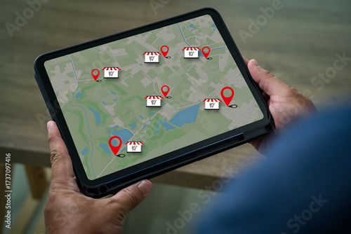 Foto Local search marketing concept on tablet map with location pin and store icons s