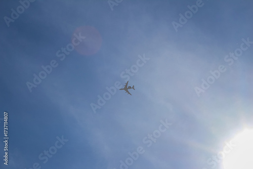Wallpaper Mural Passenger Airplane Flying in Blue Sky Near Sun Torontodigital.ca