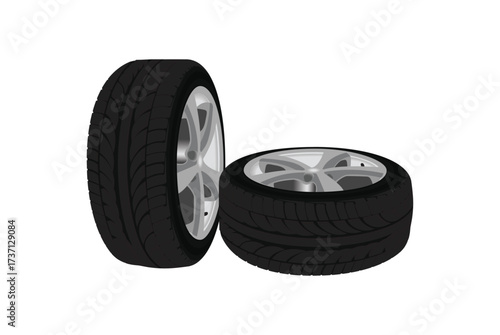 Two car tires with silver rims one upright and one stacked horizontally