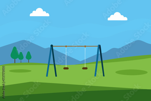 Empty playground swing set in a grassy park with mountains and clouds