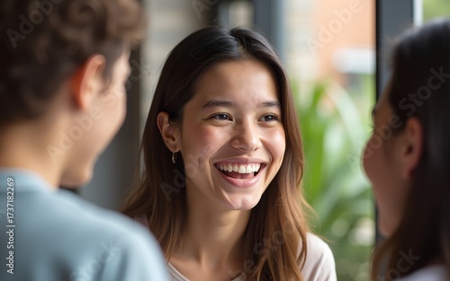 Happy young woman smiling and interacting with friend in casual setting, showcasing joyful moment of connection and friendship. High quality