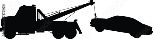 Silhouette of a Tow Truck Hooking Up a Car