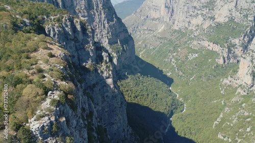 Drone footage of Vikos Gorge in Epirus, Greece, showing steep cliffs, lush greenery, and dramatic mountain landscape. Perfect for travel, nature, and documentary projects.