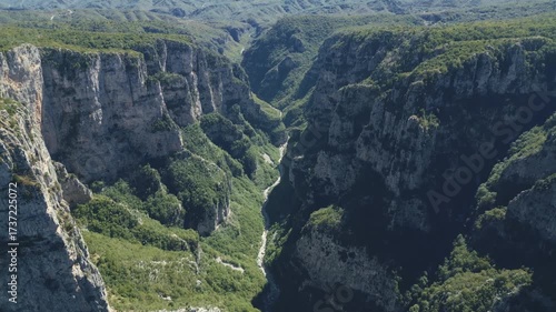 Drone footage of Vikos Gorge in Epirus, Greece, showing steep cliffs, lush greenery, and dramatic mountain landscape. Perfect for travel, nature, and documentary projects.