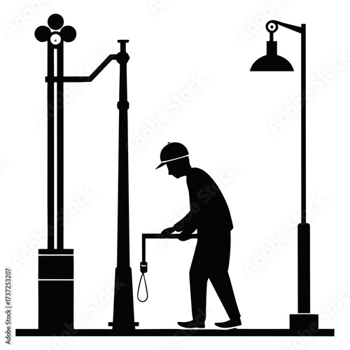 Worker maintaining streetlights in a silhouette