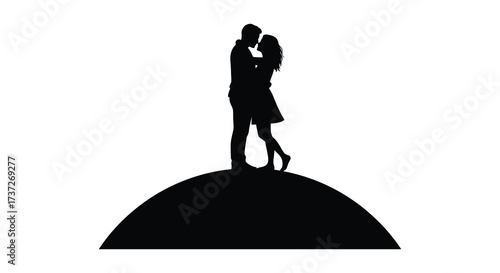 Silhouetted couple embracing on a hilltop against a glowing background