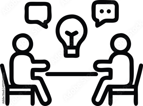 Two people discussing ideas around a table with a lightbulb meeting discussion