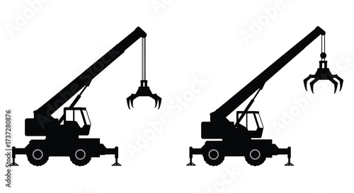 Two black silhouette cranes with mechanical claws are prominently displayed
