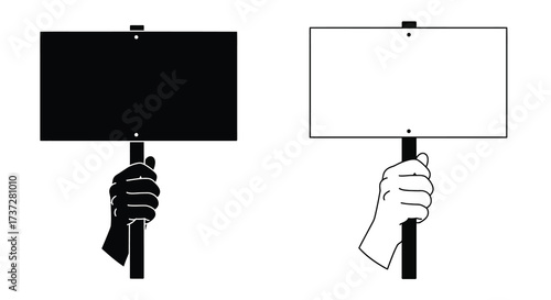 A hand holding two protest signs one black and one white