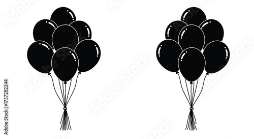 Two clusters of black balloons tied with strings on white background