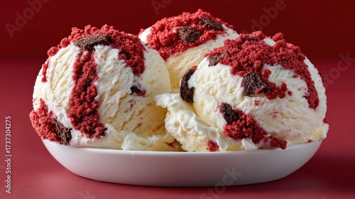Red velvet ice cream scoops with chocolate chunks in a bowl
