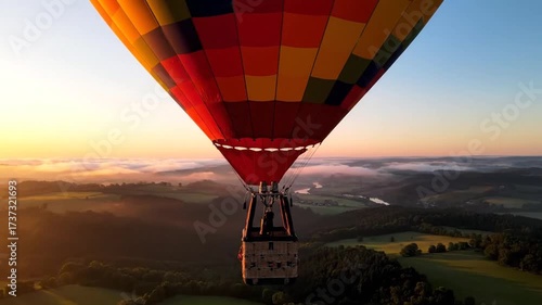 A Graceful Hot Air Balloon Ascends Over a Serene Landscape, Gently Floating in Soft Light