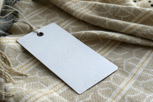 Blank White Rectangular Hang Tag Mockup on Beige Woven Plaid Scarf or Wool Fabric