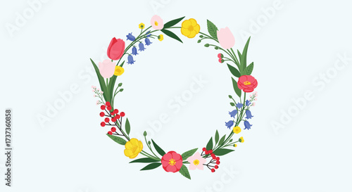 A delightful circular arrangement of colorful spring flowers and greenery forms a beautiful floral wreath.