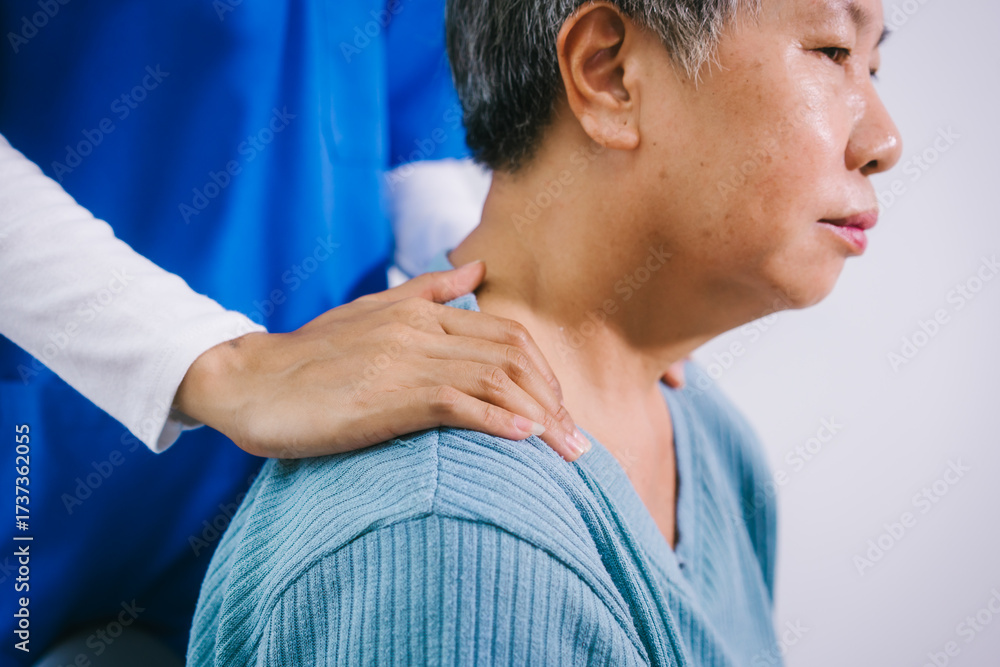Fototapeta premium An Asian female nurse provides caring home care to an elderly woman, assisting with arm movement exercises, physical therapy,and rehabilitation to improve joint function, strength,overall well-being