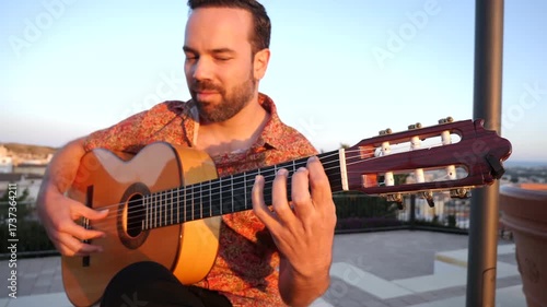 Professional musician passionately playing spanish flamenco music on a classical guitar. Spanish culture and traditional stringed instrument