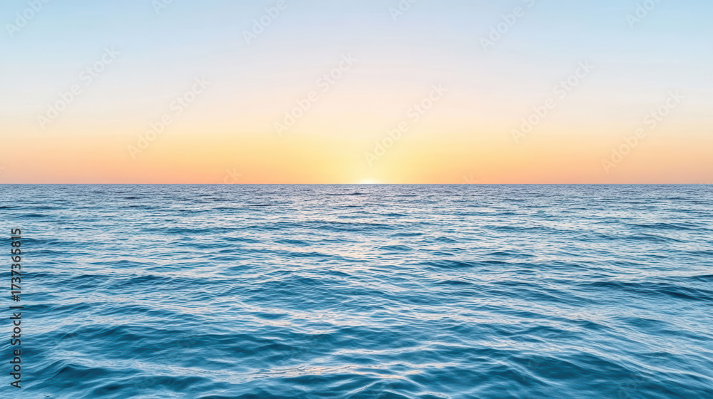 Fototapeta premium Vast ocean horizon with colorful sunset sky creates peaceful atmosphere