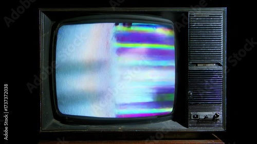 Vintage Television Static: An aged television set displays a vibrant cascade of analog static, a nostalgic symbol of a bygone era, showcasing the unique beauty of signal disruption.