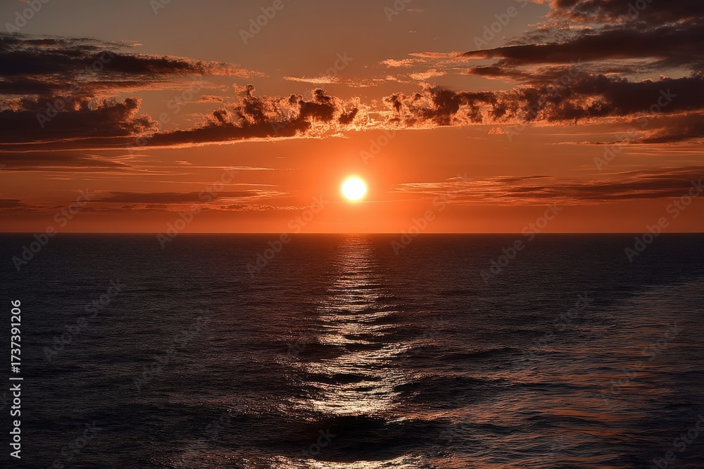 Naklejka premium As the sun begins to set gracefully over the vast ocean surface