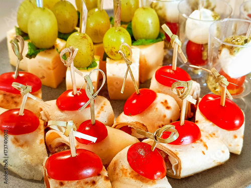 Ready-made appetizers on skewers. Rolled pancakes with filling.