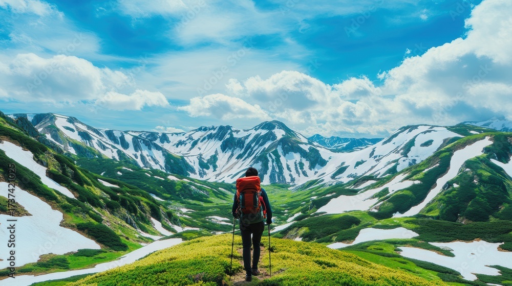 Fototapeta premium Backpacker entering snowy mountain pass 