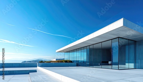 Minimalist modern building with glass facade, blue sky, clean lines, architecture