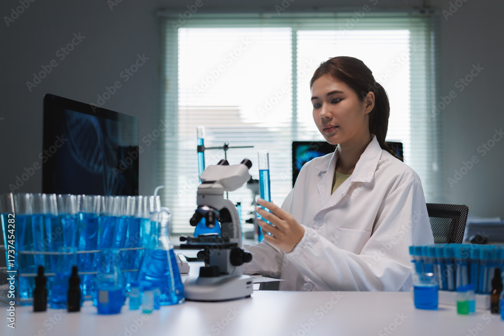 Fototapeta premium Young asian scientist conducting research in laboratory