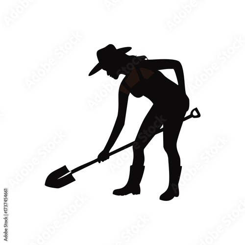 Silhouette of a woman in overalls digging with a shovel Keywords: woman, silhouette, gardener
