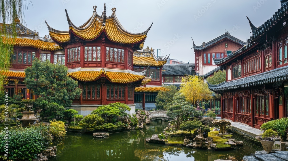 Naklejka premium Traditional Chinese architecture with golden rooftops in a classical garden setting.