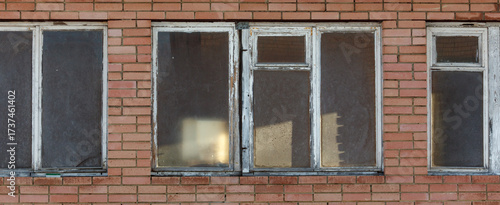 A brick building with a window on the left side