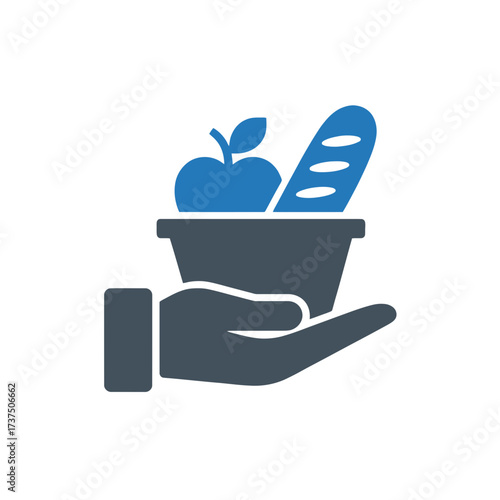 Hand holding a basket of food symbolizing charity, donation, and support for those in need