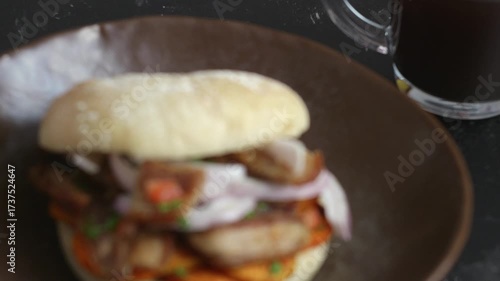 Bread with pork rinds and a cup of coffee moving away from the shot and coming into full focus.