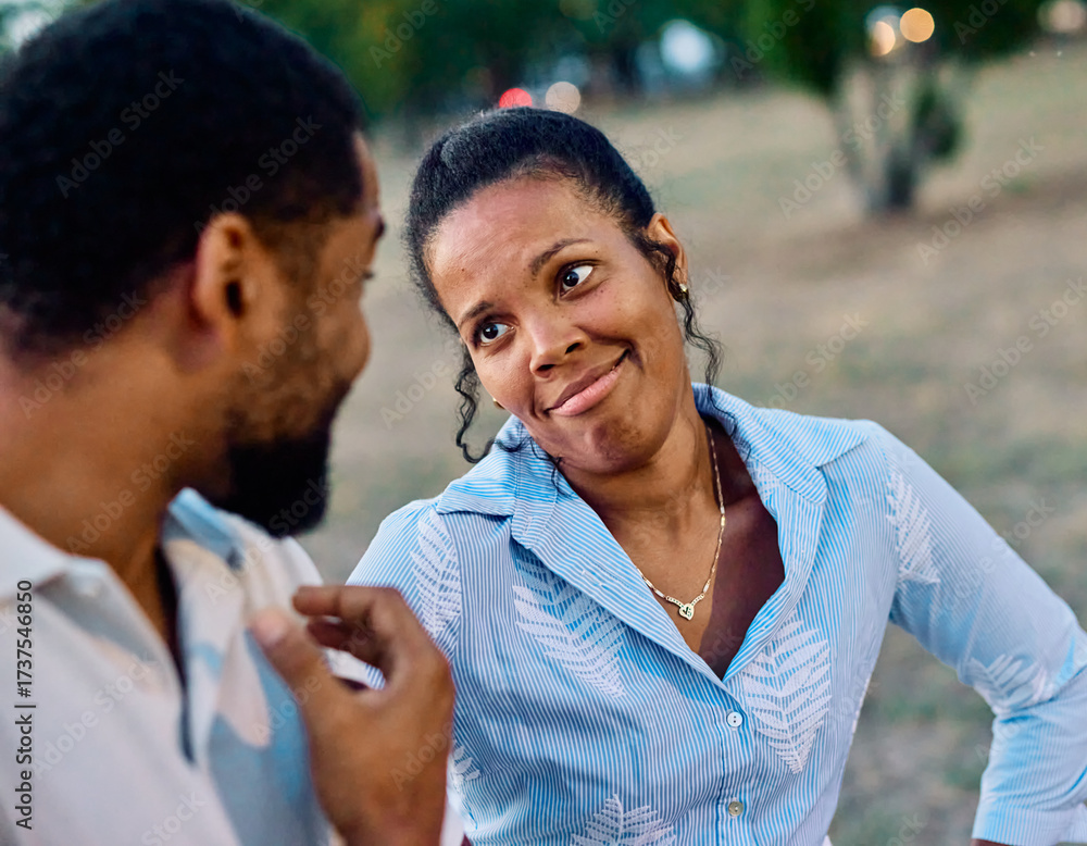 Obraz premium Portrait of a happy young couple, woman and man, black couple having fun walking and talking holding hands and bonding in park outdoors