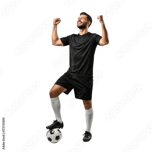Joyful male footballer celebrating victory with soccer ball underfoot dynamic pose
