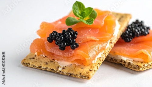 Crackers with salmon, caviar, and mint