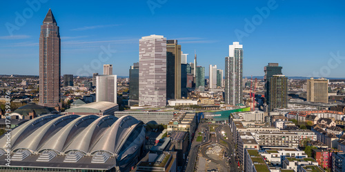 Aerial view of the Messeturm skyscraper and Messe Frankfurt exhibition center under a clear blue sky, Frankfurt am Main, Hesse, Germany.