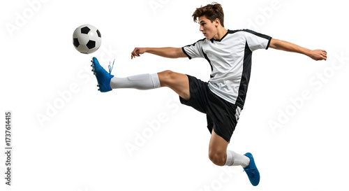 Young male soccer player performing a dynamic mid-air kick with a soccer ball, isolated on black background, perfect for sports and athletic themes